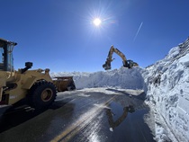 Construction equipment removes snow and debris from the avalanche closure on U.S. 395 along Mono Lake in March 2023.