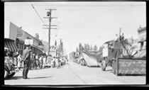 An undated black and white picture of a Parade on Main Street in Bishop.