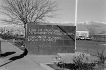 A black and white photo showing the old District 9 Division of Highways sign. (Undated)