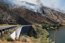 Smoke billows from the flames in the hills alongside Topaz Lake in the Slinkard Fire in 2017.