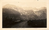 A black and white photo by Philip Weverka of Tioga Pass with snow in the mountains from 1928.
