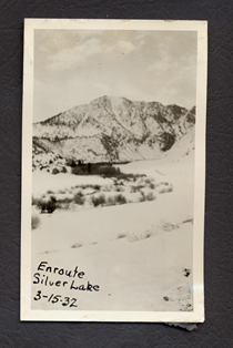 A black and white photo of Silverlake with snow in the mountains. Writing on the picture reads "Enroute Silver Lake 3-15-32."