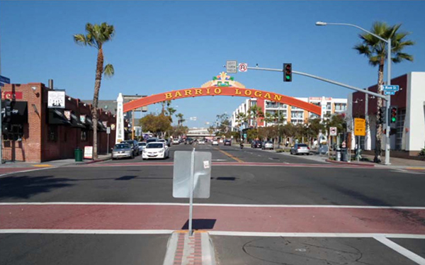 A 'small-town' looking multi-lane intersection with a decorative arch crossing the road.