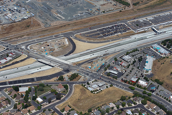 From above, a view of multi-lane roads intersecting with each other.