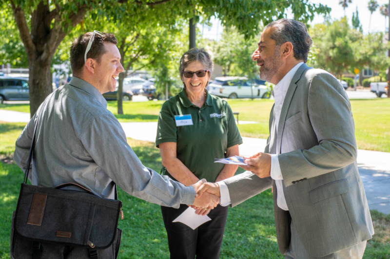 Event Photo: Sacramento City Council Member Sean Loloee greets event attendees at Winners Circle Park in the Dixieanne Neighborhood of North Sacramento after announcing a grant award to improve and beautify the alleys in the neighborhood.