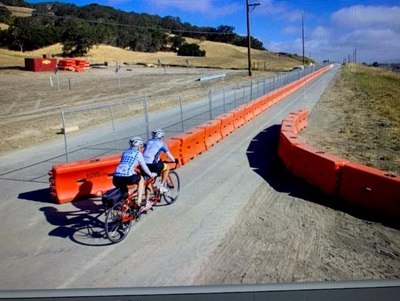 Photo of two bicyclists on a bike path near Highway 101 and San Antonio Road in Marin County.