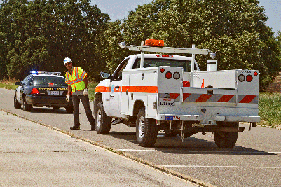 Highway construction is one of the most dangerous occupations in the United States, according to the U.S. Bureau of Labor Statistics. This photo was taken as part of Caltrans Move Over safety campaign to show how close workers are to moving traffic. The Move Over Law requires drivers to move over a lane, if safe to do so, or slow down, when passing vehicles with flashing amber lights.