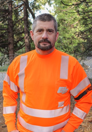 Caltrans Equipment Operator II Joe Vaars narrowly escaped his vehicle after a tree fell and smashed his truck. He then proceeded to direct traffic.