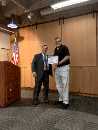 Maintenance Division Chief Tony Tavares, left, presented Headquarters Customer Service Officer Patrick Olsen with the Maintenance Gold Partnering Award for communicating, refining and streamlining the Customer Service Request process in partnership with 12 districts.