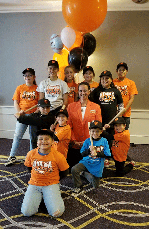 Caltrans District 2 Native American Liaison and Los Molinos Junior Giants Coach Kendee Vance was inducted into the Junior Giants Hall of Fame on March 26 in San Francisco. She is pictured here in the orange blazer, surrounded by her league players.