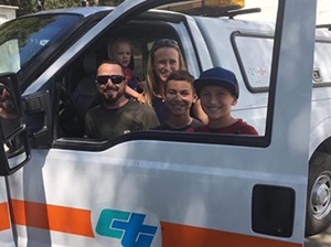 Left to right (back row) Kannon and Honalee Newman, (front row) Michael Quinliven, Johnathan Garcilazo and Takoda Newman pose for a photo after Quinliven saved the woman and children from the Mendocino Complex Fire as it engulfed State Route 20 on July 29.