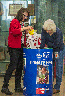 From left to right, Caltrans Resource Analyst Dinah Lee and California Public Records Act Coordinator Marcy Freer put food donations in a Sacramento Food Bank barrel at Headquarters.