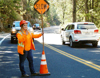Kharli Robertson directs traffic on Highway 4 near Calaveras Big Trees State Park.