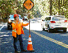 Kharli Robertson directs traffic on Highway 4 near Calaveras Big Trees State Park.