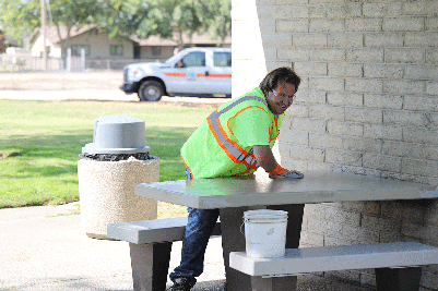 Howard Training Center worker Dustin Benge cleans picnic tables at the southbound State Route 99 Turlock Rest Area.