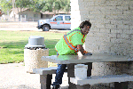 Howard Training Center worker Dustin Benge cleans picnic tables at the southbound State Route 99 Turlock Rest Area.