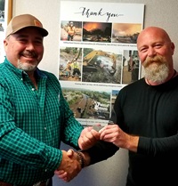 District 5 Maintenance Manager Lee Chaves, left, congratulates South Region Manager Chris Chalk, who took photographs charting Caltrans’ work to reopen Highway 101 after the Montecito flood and mudslide.