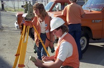 A Caltrans survey team works at the scene of the Cypress Street Viaduct collapse. Mark S. Turner, shown taking notes, still works for Caltrans. Toni Scoralle, standing, spent 35 years with Caltrans before dying at age 57 in 2017.