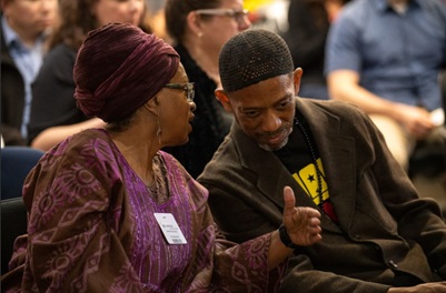 Grace and Yusuf Ali, the event's featured speaker, confer at the Black History Month event at Caltrans Headquarters on Feb. 27.