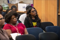 La Keda Huckabay, left, and Lakeisha Daniels listen to a presentation at the Black History Month Program.