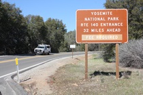 This roadside sign reminds motorists that if they intend to continue on to Yosemite National Park, they will need to pay a fee.