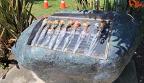 Memorial Rock in front of District 5 office. Flowers placed over names of the eight lost in D5 during ceremony by fellow highway workers.