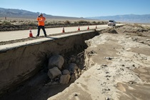 In District 9, public information officer Christopher Andriessen surveys damage to State Route 190 around Owens Lake just west of the Death Valley National Park boundary. (Photo by Michael Lingberg)