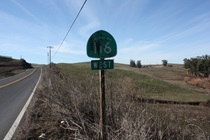 After one of its many junctions, this one east of Petaluma, SR-116 is identified with a rather blemished sign.