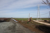 Power lines venture northward from their origin in the PG&E Grand Island Substation beside SR-220.