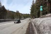 Graffiti vandals and perhaps the side of heavy machinery have impacted this highway sign between Tahoe City and Truckee.