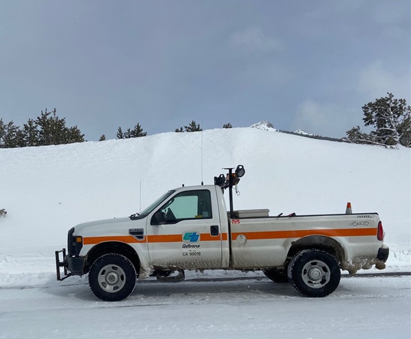 Caltrans vehicle dwarfed by snow on State Route 88 in Hope Valley near Blue Lakes 