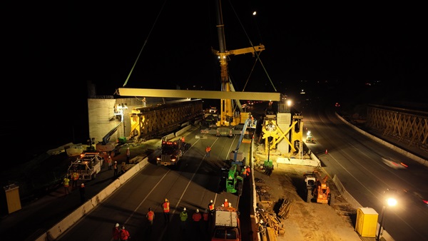 The first of 82 steel girders is placed over U.S. Highway 101 in Agoura Hills on April 16 as part of the Wallis Annenberg Wildlife Crossing project.