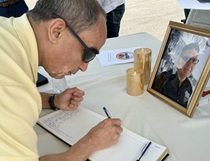 Adam Siddiqui signs the guest book in Alex Rodish’s memory in District 12.