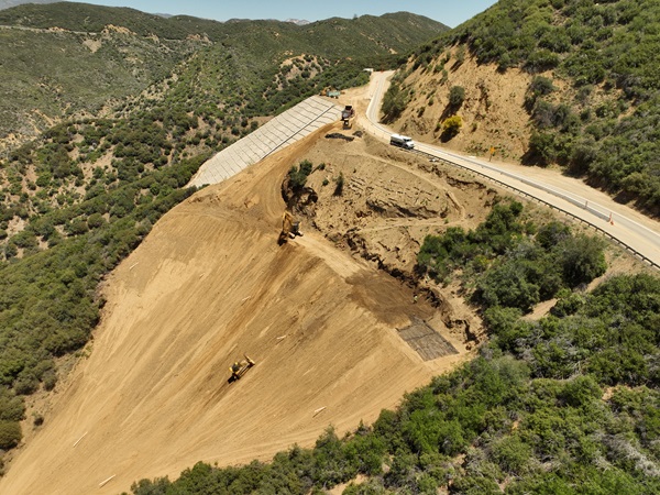 Bulldozer climbing up steep slope on State Route 33 in Los Padres National Forest in District 7.
