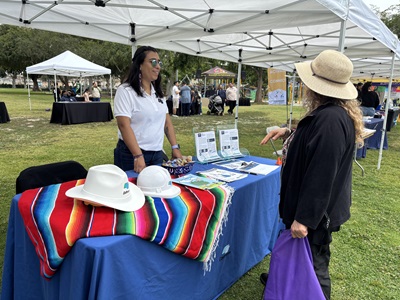 Caltrans District 7 Public Information Officer Diana Jimenez speaks with a Long Beach resident about the Vincent Thomas Bridge Deck Replacement Project.