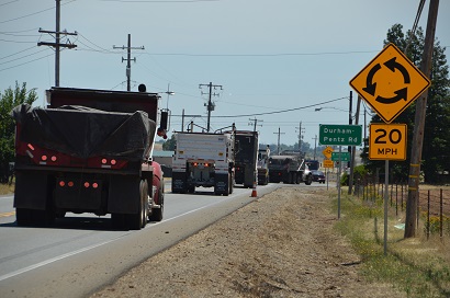 Dump trucks approach the temporary roundabout installed at State Route 191 and Durham-Pentz Road.
