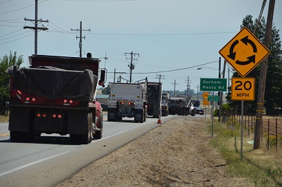Dump trucks approach the temporary roundabout installed at State Route 191 and Durham-Pentz Road. Dump trucks approach the temporary roundabout installed at State Route 191 and Durham-Pentz Road.