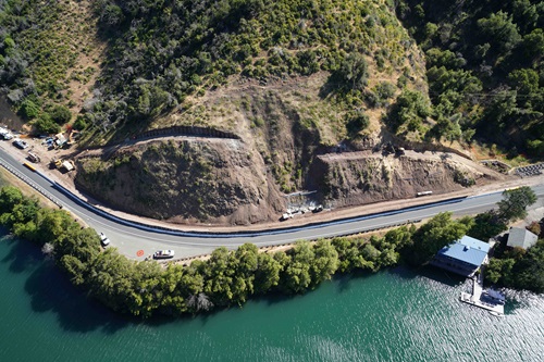 Aerial view of state route 20 near Blue Lakes. Construction equipment is at work on the shoulder. 