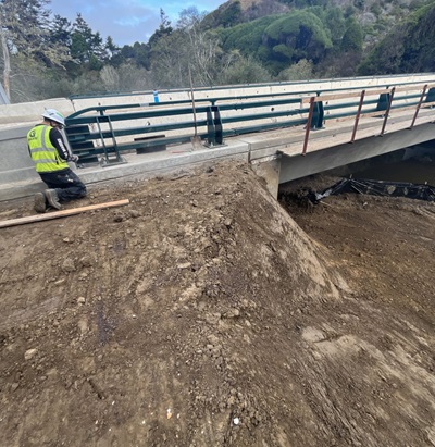 A contractor works on guardrail on the Elk Creek Bridge on State Route 1 in Mendocino County. 