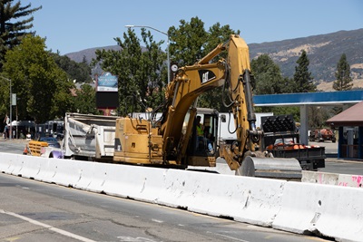 An excavator works along US101 in Hopland.