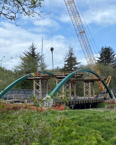 A crane installs arches on the Hunter and Panther Creek bridges as part of a bridge replacement project along U.S. 101 north of Klamath in Del Norte County.