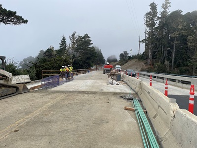 Construction crews install a concrete barrier and pedestrian railing on west side Jack Peters Creek Bridge on Route 1 in Mendocino County