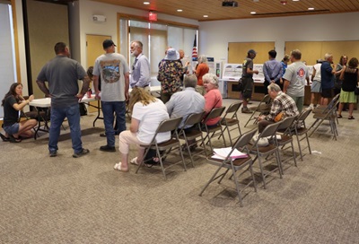 District 1 staff held an open house at the Middletown Library. Staff and community members assemble in the meeting room and converse. 