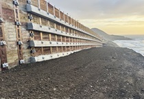 A retaining wall along Route 1 in Mendocino County near Westport stretches into the sunset with the Pacific Ocean in the background. 
