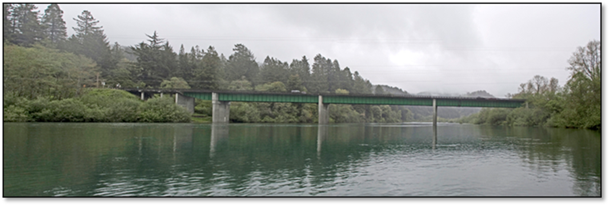 Wide view of Dr. Fine Bridge in Del Norte County. The bridge spans across the Smith River. 