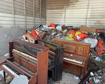 Trash picture showing three discarded pianos. For more information, call (619) 688-6670 or email CT.Public.Information.D11@dot.ca.gov