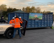 Caltrans employees helping unload trash from a pickup truck. For more information, call (619) 688-6670 or email CT.Public.Information.D11@dot.ca.gov