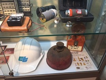 Display case with old highway construction equipment. For more information, call (619) 688-6670 or email CT.Public.Information.D11@dot.ca.gov