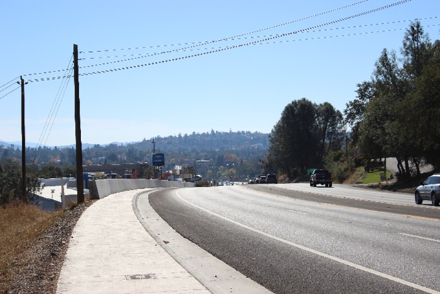 Photo of State Route 49 (facing south) between Palm Avenue and Marguerite Mine Road. Photo taken after Caltrans constructed a sidewalk, widened shoulder and retaining wall with concrete barrier for improved pedestrian and bicycle movement. 