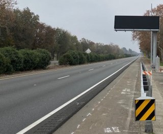 Photo of overhead changeable message sign that provides motorists real-time traffic safety and guidance information